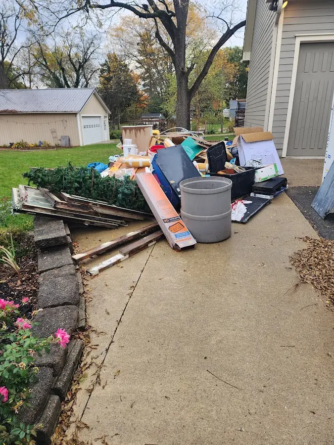 Dumpster being loaded with debris for 30 Yard Dumpster Rental in Oliver Springs